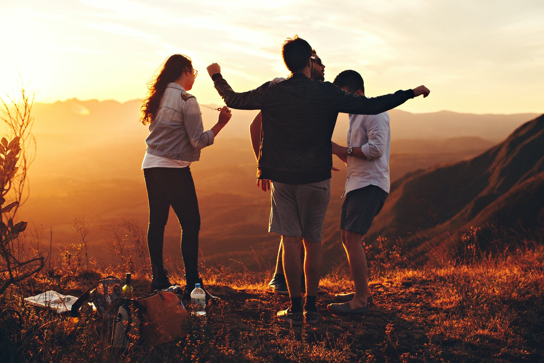four teens standing on top of a hill during sunset. text says adapt lab - adolescent decisions and positive trajectories